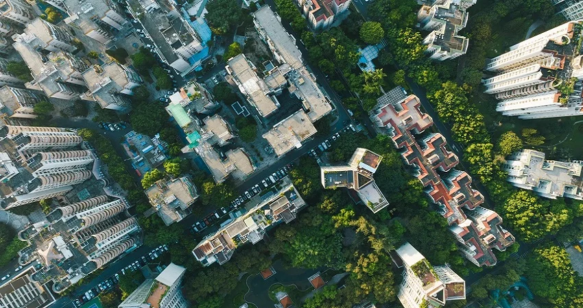 A birdseye view of buildings surrounded by trees.