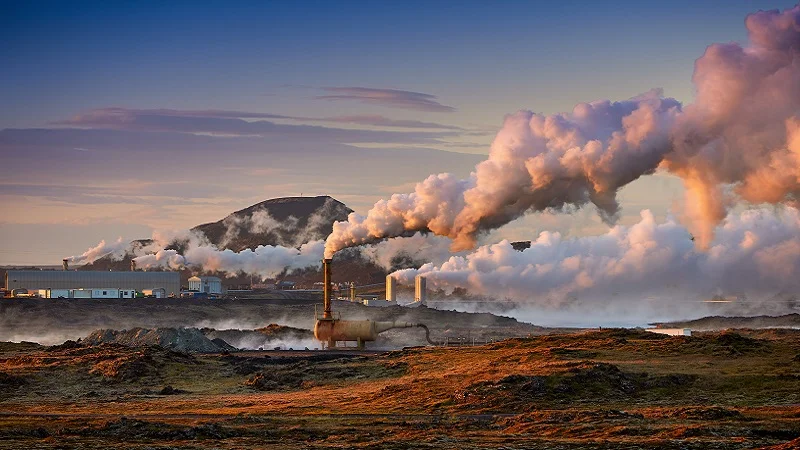 Geothermal plant blowing steam into the air.