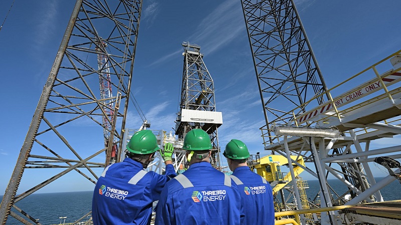 Three engineers from THREE60 inspecting an oil rig.