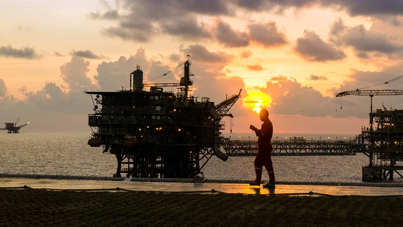 Image of a man in front of a platform in the sunset