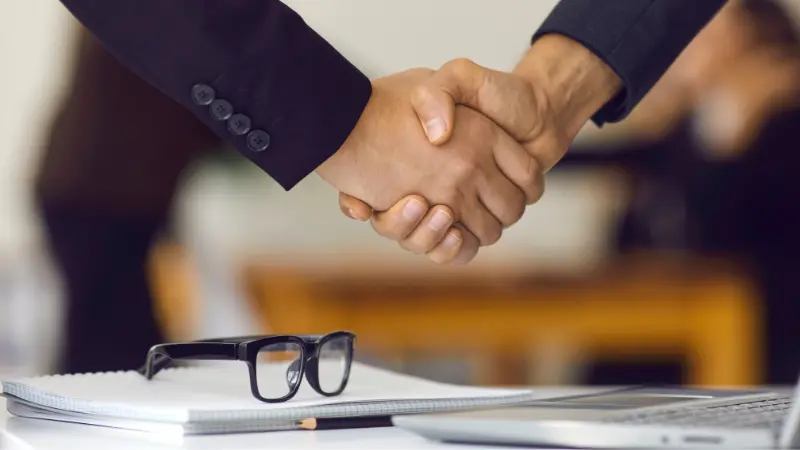 Two men shaking hands over an agreement 