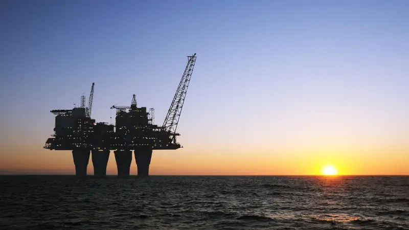 Rig in the sea at sunset