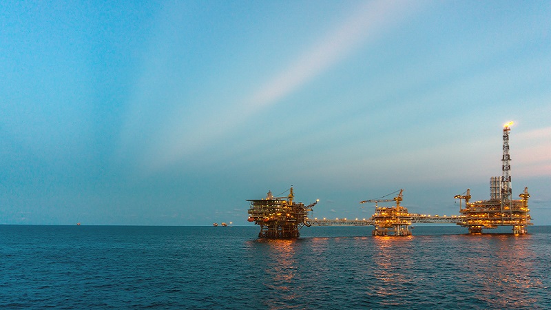 Image of three rigs out to sea