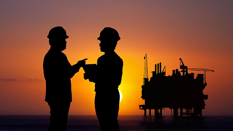 oil worker silhouettes offshore well intervention