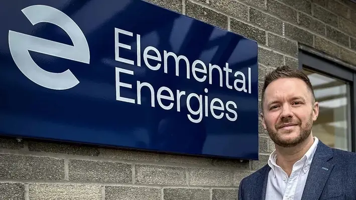 Image of Ross Provan in front of an Elemental Energies sign