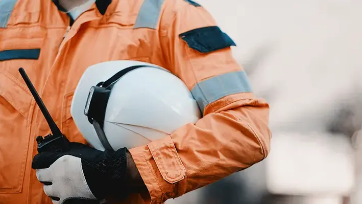 Man_orange_suit_white_helmet_walkie_talkie