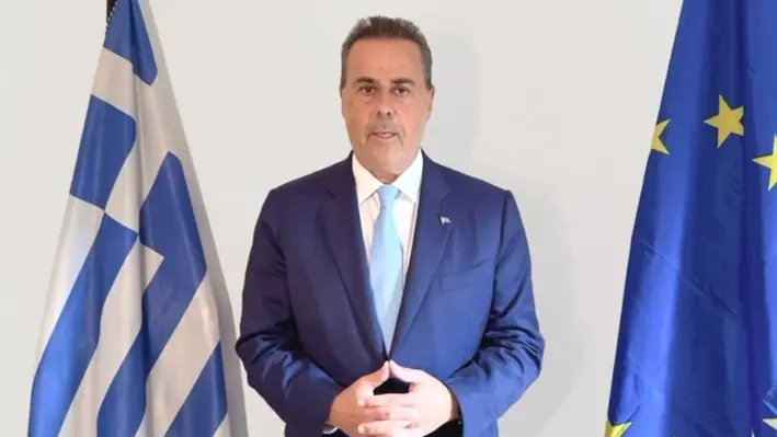 a_man_with_two_flags_behind_him