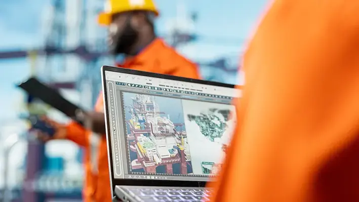 Closeup engineer orange suit laptop 2
