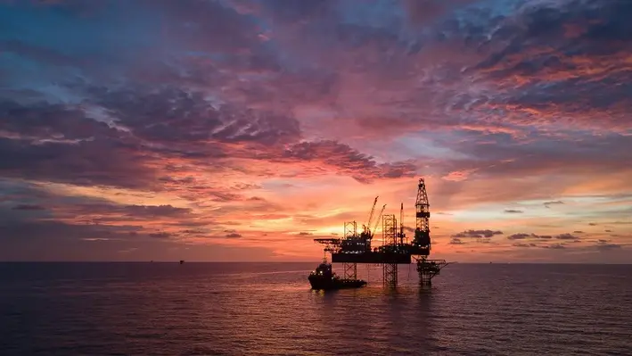 The project will demystify decarbonisation economics. (Image source: Kent) An offshore oil platform at sunset.