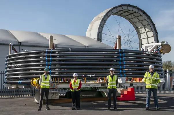 Magma Global team proud of the world's first high pressure, high temperature composite production riser pipe. (Image Credit: Magma Global)