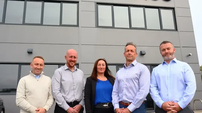 The five directors of Oilenco posing for a picture in front of the Oilenco building.